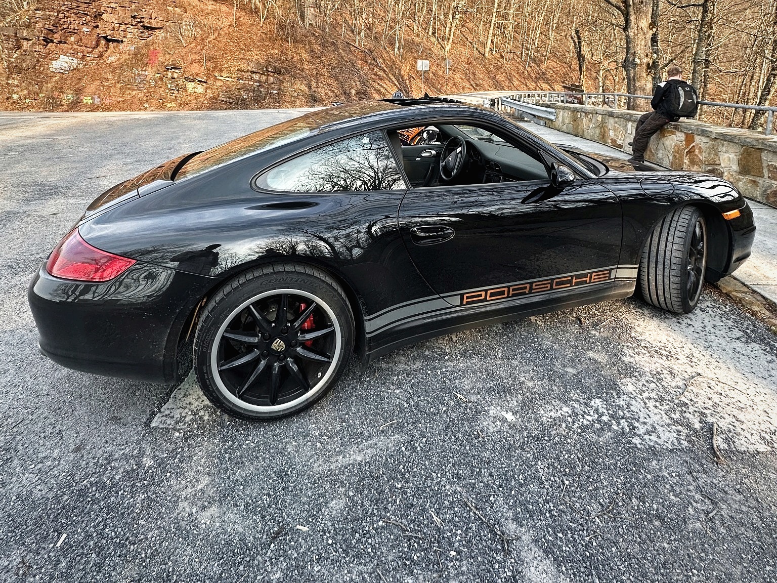 Black 2007 Porsche 911 Carrera 4 stopped on a mountain road