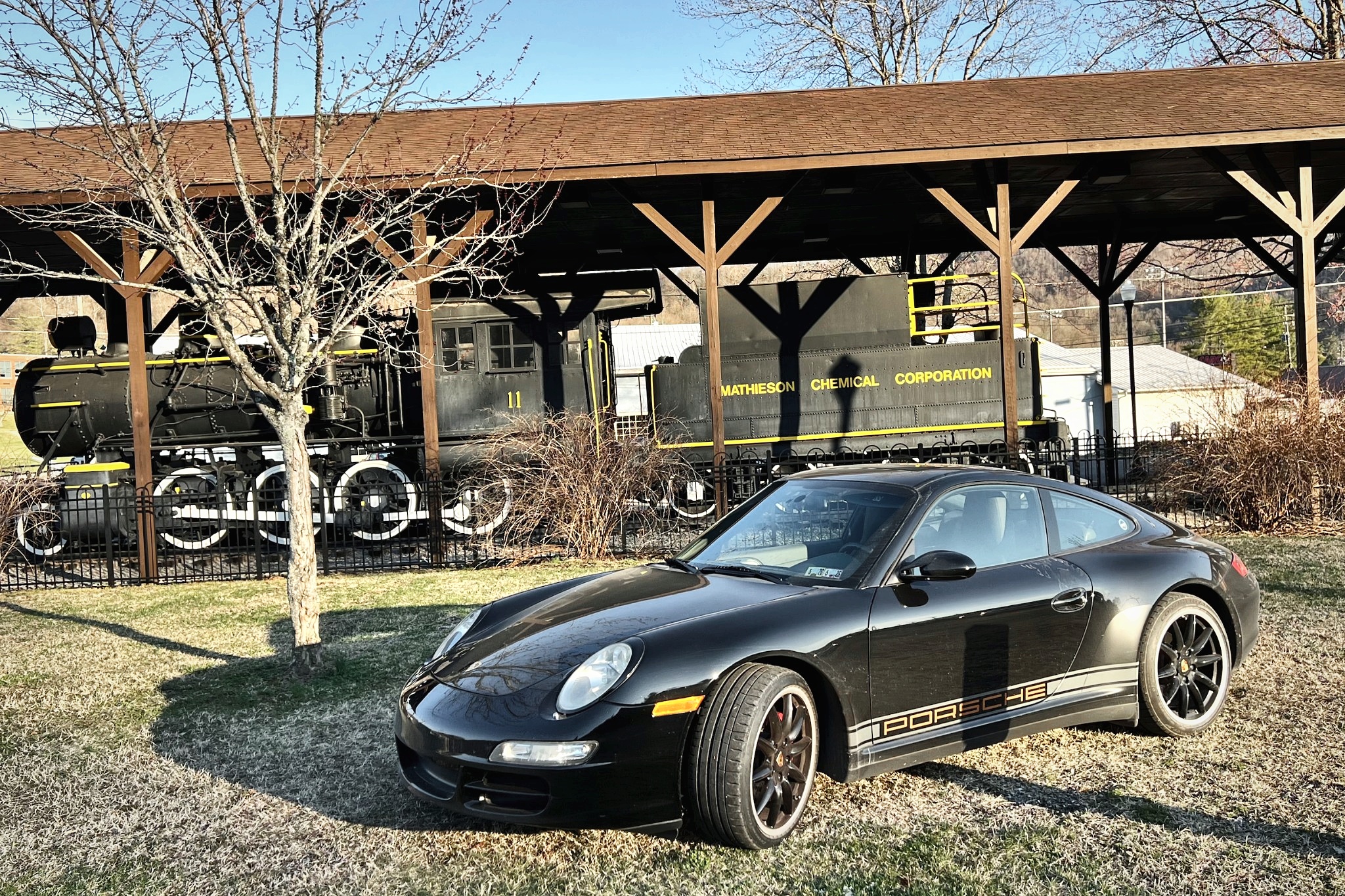 The Carrera 4 parked beside a historic train stop during a road trip